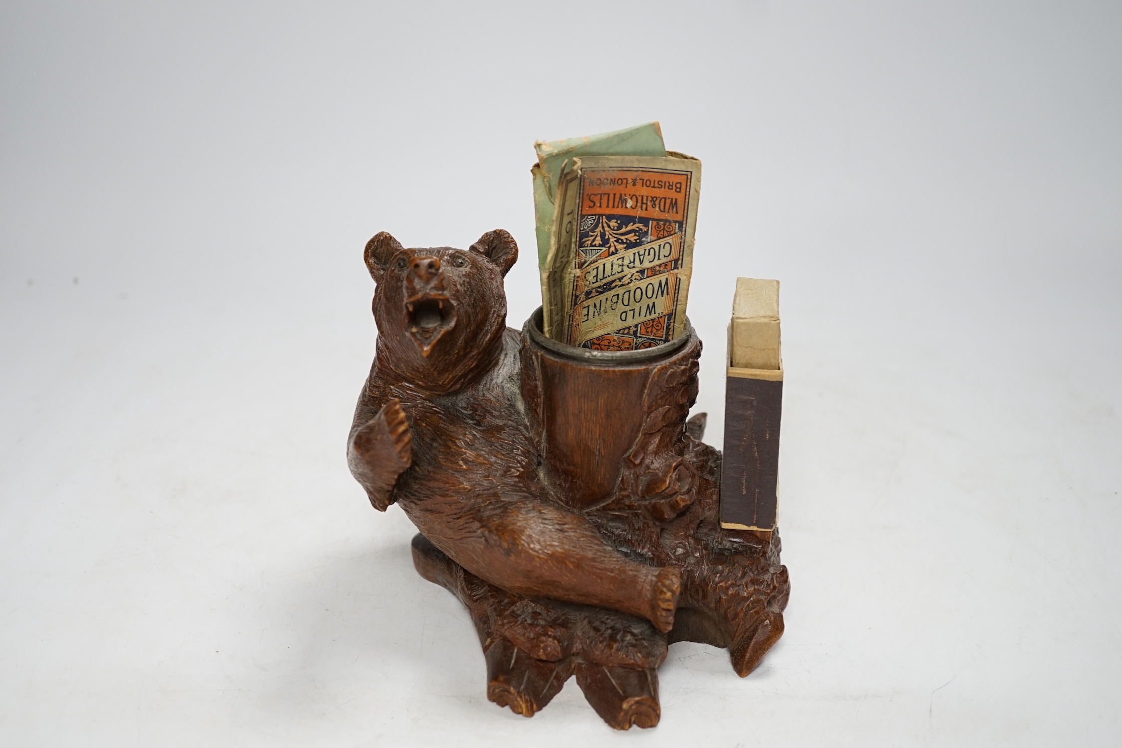 A carved Black Forest bear matchbox holder, 13cm high